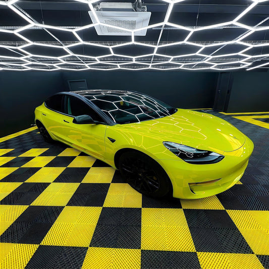 Plastic tile flooring installed in an automobile garage, providing a sturdy and non-slip surface