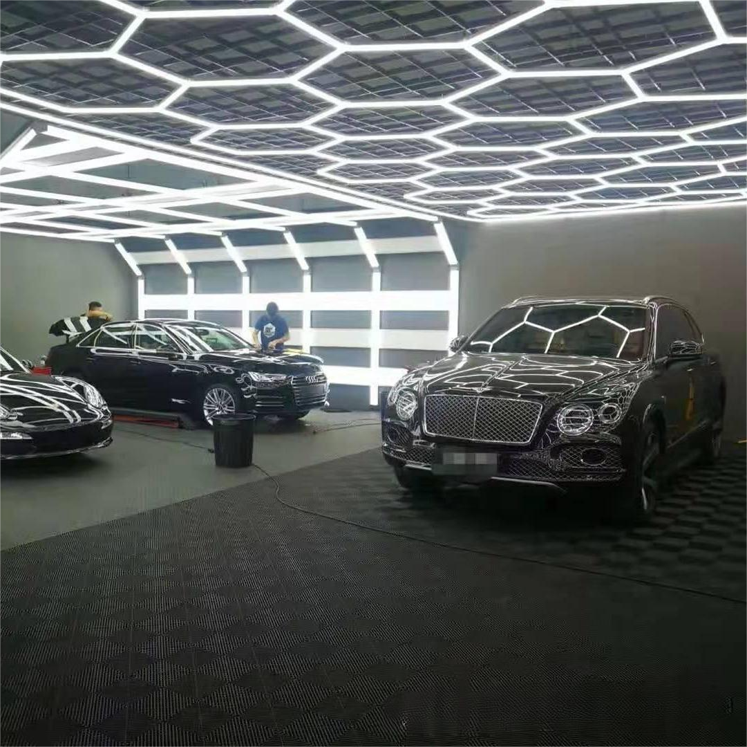 Plastic tile flooring installed in a car showroom, offering a clean, non-slip, and professional surface for display areas